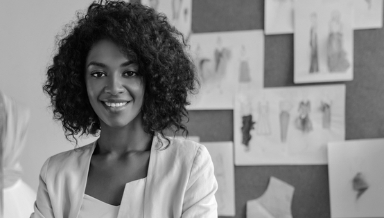 Beautiful curly brunette dark-skinned female, confident, at her creative work. 