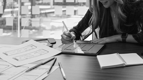 Creative woman sketch planning application process development for mobile phone - symbol of success.