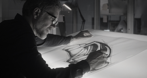 Medium close-up of a male car designer drawing concept art
