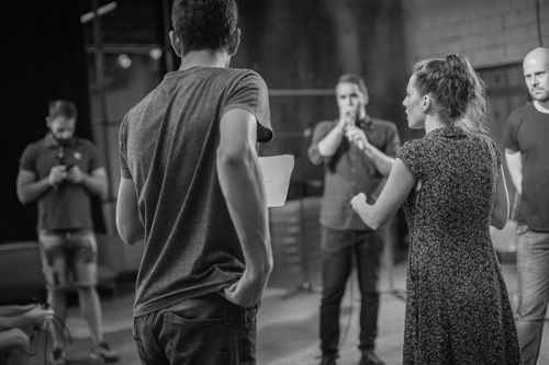 Behind the scene. Director of the play rehearses the play with the actors according to the script