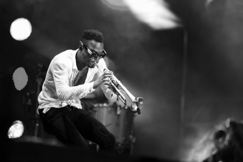 Passionate male musician on stage, playing trumpet