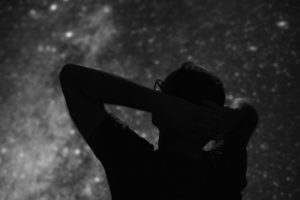 Silhouette of a man with Milky Way starry skies.