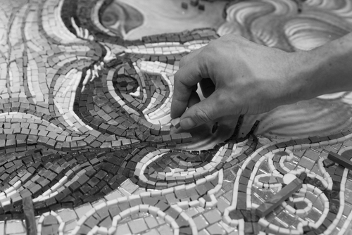 Man making mosaic art. Process of making mosaic.