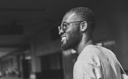 young man smiling black and white