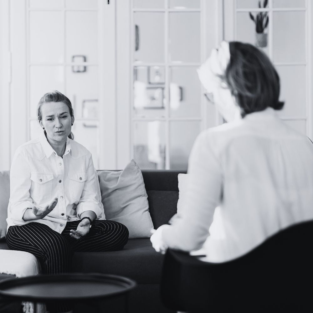 Two women having a serious conversation during a therapy session