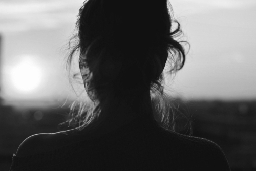 Female portrait, back view, looking hopeful a the sunrise 