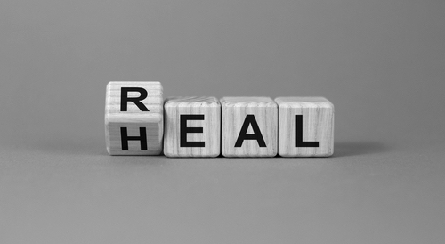 Real heal symbol. Fliped a wooden cube with words 'Real heal'. Heal Concept.
