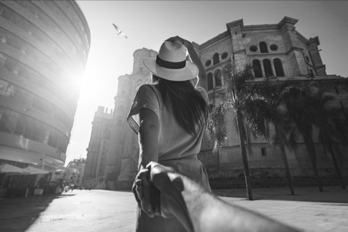 Woman, running in the city, grabbing partner hand, holding tight - symbol of clinging.