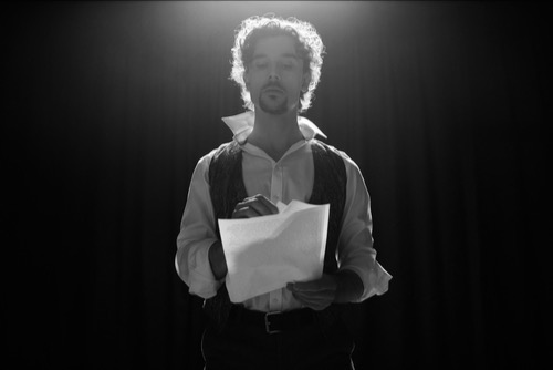 Theatre performer man, with his scrips papers, alone - a sense of solitude and inward struggles.