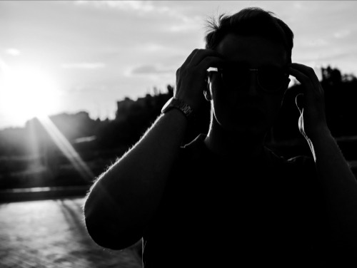 Man with face in the shadow, sunlight behind him - emotionally connecting to himself, ready to explore aligned actions.