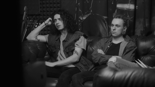 Band member, sitting, looking bored or upset 