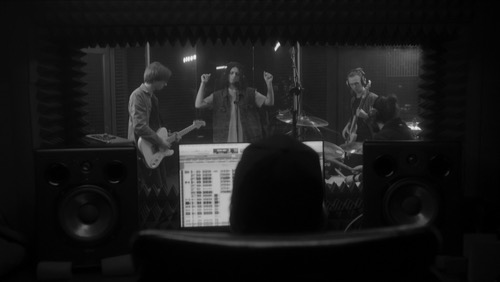 Music band in a recording studio - in a good working, harmonious relationship