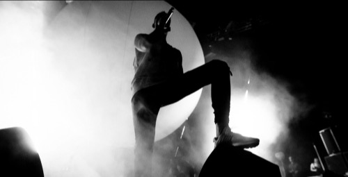 Musician performer holding microphone on stage.