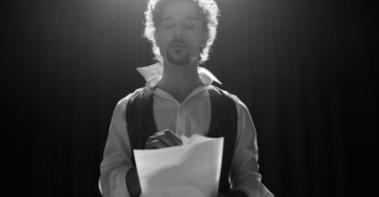 Man actor on stage rehearsing a theatre piece.